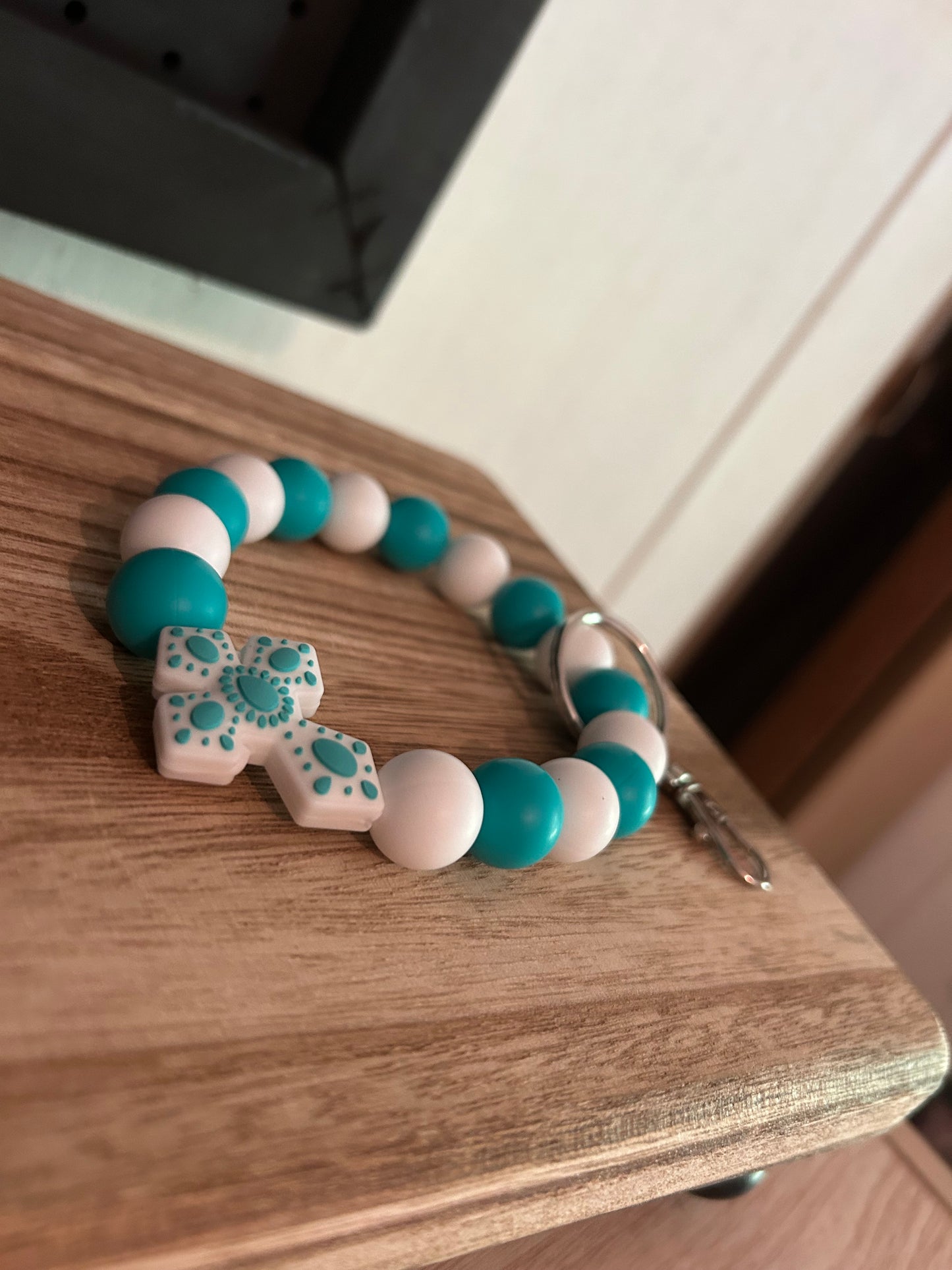 Teal and white cross wristlet keychain