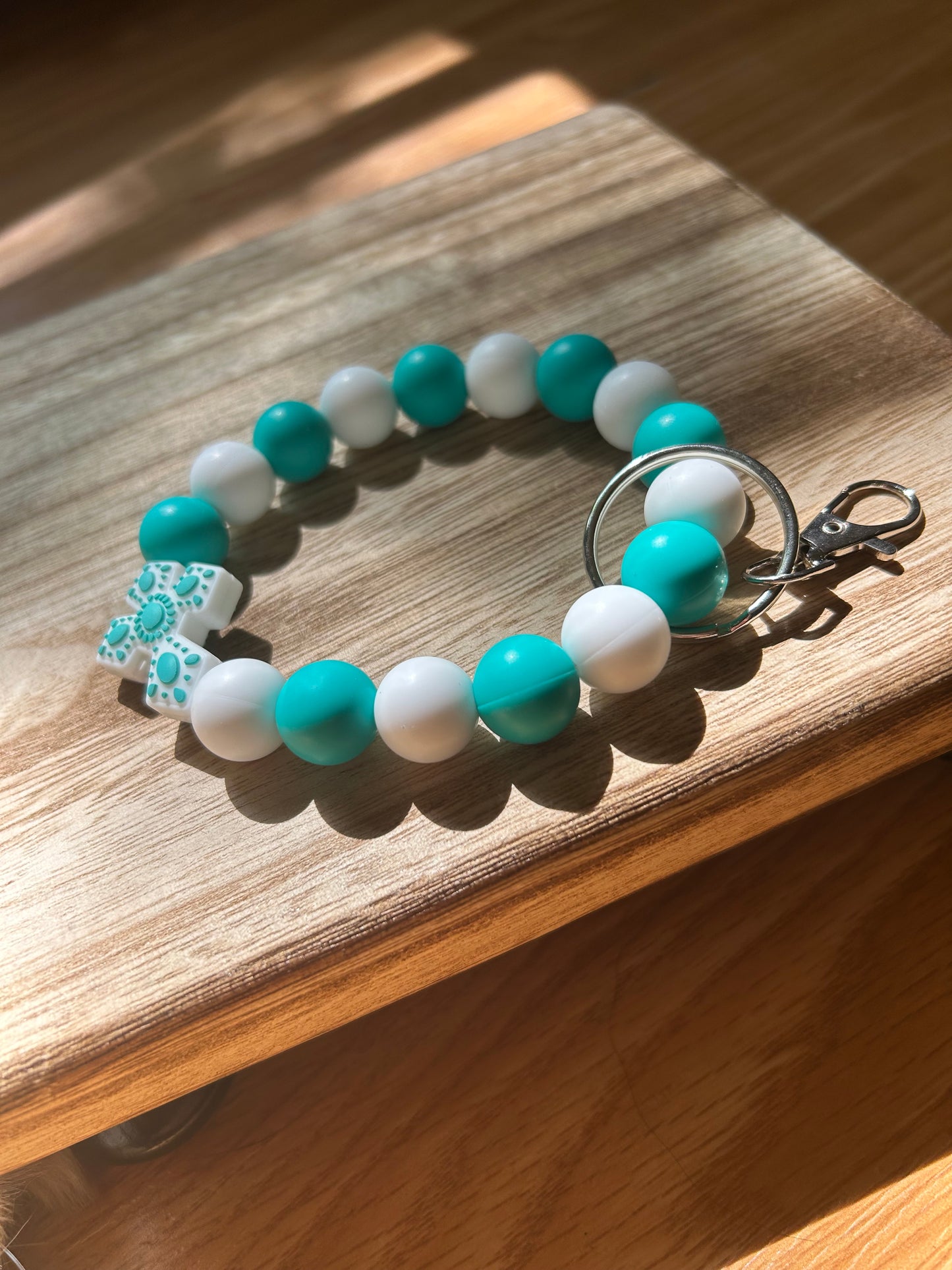 Teal and white cross wristlet keychain